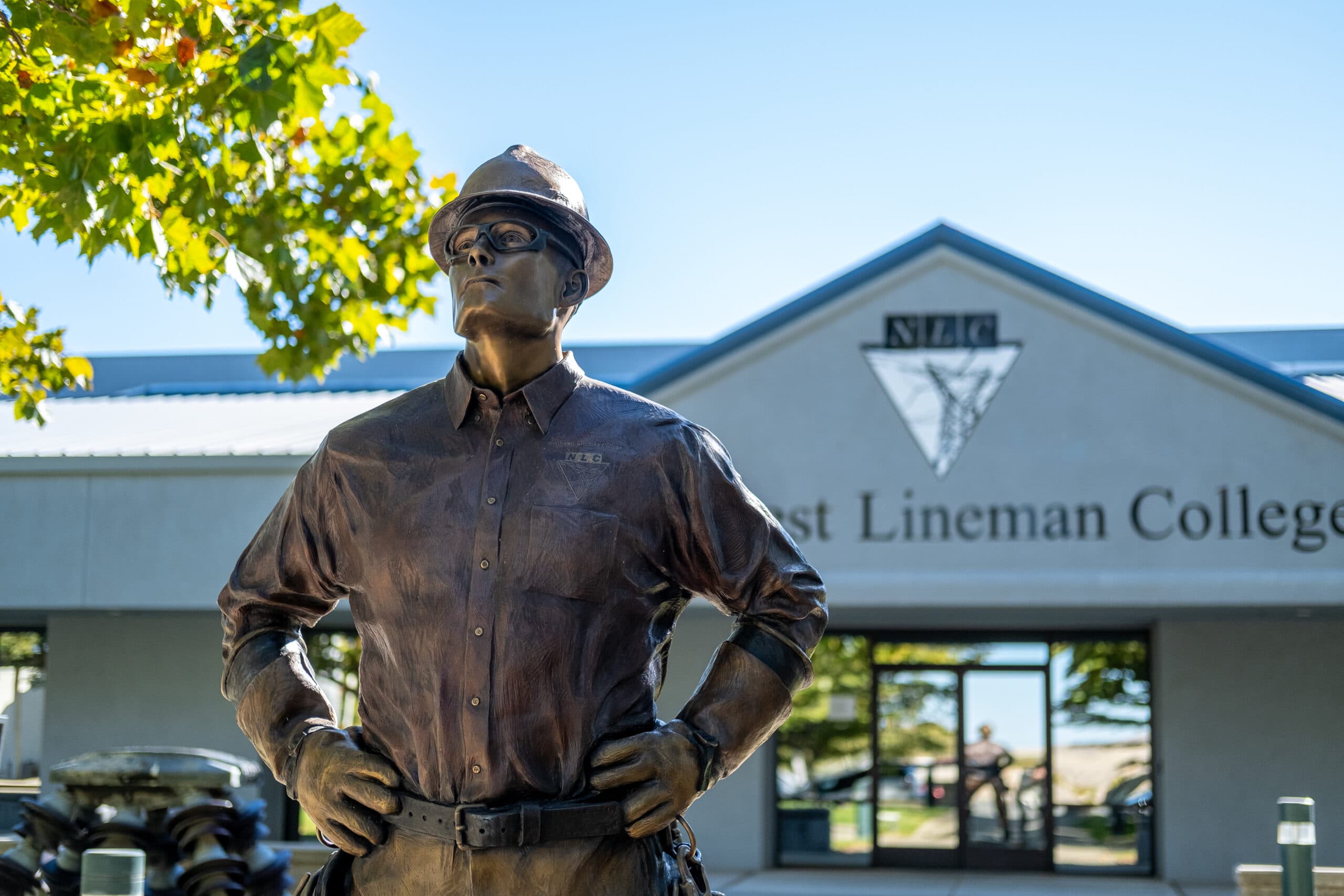 bronze lineman statue in front of CA campus entrance